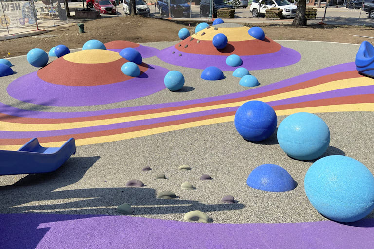 Various sized 3d safety surface spheres on a playground. Playground mounds. Playground safety surfacing. AquaSeal Resurfacing LLC. George Coon.