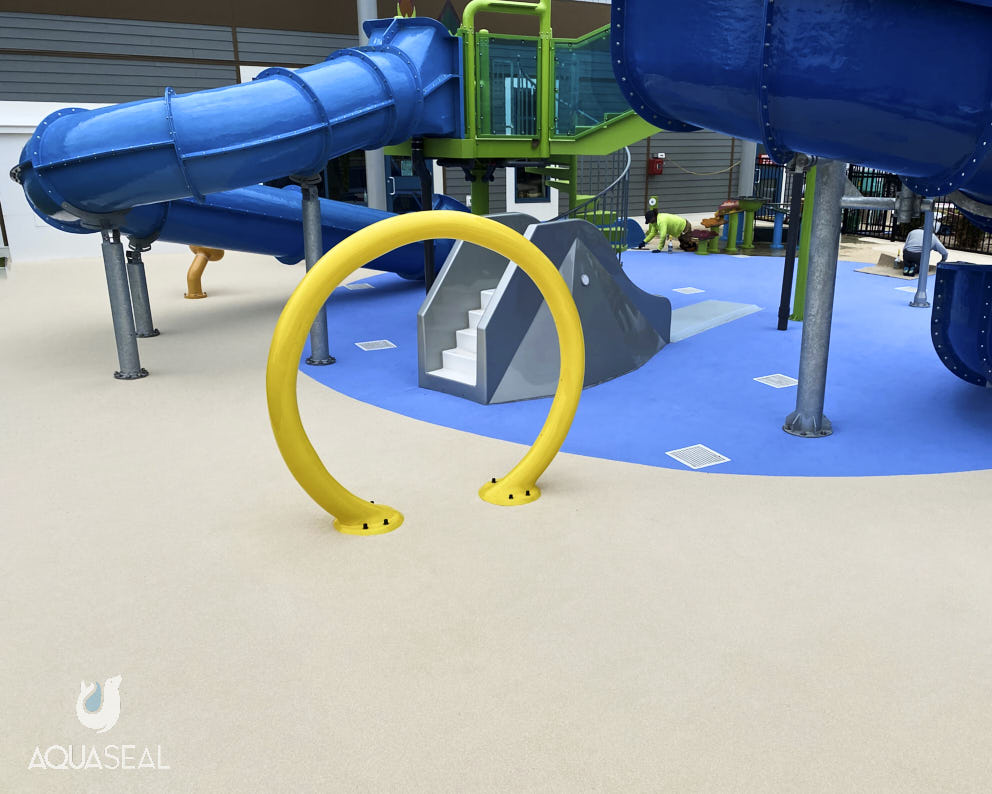 Flecks seamless safety surface installed on a playground by Aquaseal.